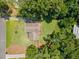Aerial view of a house with a well-maintained lawn, surrounded by mature trees and a nearby greenhouse at 2941 Foothill Trl, Marietta, GA 30066