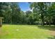 Spacious and well-maintained backyard with lush green grass and mature trees, perfect for outdoor activities at 2941 Foothill Trl, Marietta, GA 30066