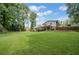 Spacious backyard with a covered patio, mature trees, grass, and a fence at 2941 Foothill Trl, Marietta, GA 30066