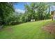 Lush green backyard with a storage shed, mature trees, and grass at 2941 Foothill Trl, Marietta, GA 30066