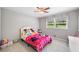 Cozy bedroom with a ceiling fan, neutral walls, carpet, and a brightly colored bed at 2941 Foothill Trl, Marietta, GA 30066