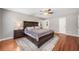 Bedroom with wood floors, ceiling fan, large bed with decorative pillows and two nightstands at 2941 Foothill Trl, Marietta, GA 30066