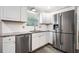 Modern kitchen with stainless steel appliances, white cabinets, and subway tile backsplash at 2941 Foothill Trl, Marietta, GA 30066