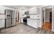 Bright kitchen featuring stainless steel appliances, white cabinets, gray countertops, and a stylish tile backsplash at 2941 Foothill Trl, Marietta, GA 30066