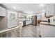 Modern kitchen with white cabinets, stainless steel appliances, and gray wood-look flooring at 2941 Foothill Trl, Marietta, GA 30066