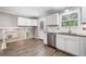 A bright kitchen with stainless steel appliances, white cabinets and a window over the sink at 2941 Foothill Trl, Marietta, GA 30066