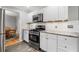Updated kitchen with stainless steel appliances, granite countertops, and white cabinets at 2941 Foothill Trl, Marietta, GA 30066