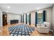 Bright living room featuring hardwood floors, neutral walls, and three windows with blue drapes at 2941 Foothill Trl, Marietta, GA 30066