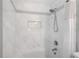 Close up of a shower with marble walls, a shower head and tiled accents at 2941 Foothill Trl, Marietta, GA 30066