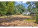 Spacious backyard with mature trees and potential for outdoor activities at 5601 Due West Rd, Powder Springs, GA 30127