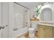 Bright bathroom featuring a shower-tub combo, floating wood shelf and modern sink at 5601 Due West Rd, Powder Springs, GA 30127
