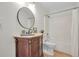 Charming bathroom with a wooden vanity, decorative mirror, and shower-tub combo at 5601 Due West Rd, Powder Springs, GA 30127