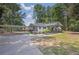 Charming single-story home with a carport, covered front porch, and manicured landscaping in a lush, wooded setting at 5601 Due West Rd, Powder Springs, GA 30127