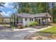 Beautiful renovated home with a welcoming front porch, black and white trim and mature trees at 5601 Due West Rd, Powder Springs, GA 30127