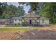 Charming home with a welcoming front porch, black and white trim, and lush landscaping at 5601 Due West Rd, Powder Springs, GA 30127