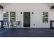 Close up of front porch with black railing, seating and decor, creating a relaxing outdoor space at 5601 Due West Rd, Powder Springs, GA 30127