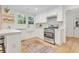 Stylish kitchen with white cabinets, updated appliances, and natural light at 5601 Due West Rd, Powder Springs, GA 30127