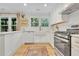 Beautiful kitchen featuring white cabinets, granite countertops, and stainless appliances at 5601 Due West Rd, Powder Springs, GA 30127