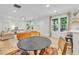 Open living room with large windows and view to the kitchen and breakfast bar at 5601 Due West Rd, Powder Springs, GA 30127