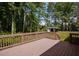 Wooden back deck overlooking a lush yard and wooded area at 995 Highway 101 S, Temple, GA 30179