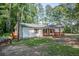 Quaint one-story home with charming front porch and shuttered windows surrounded by mature trees at 995 Highway 101 S, Temple, GA 30179