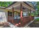Charming covered front porch with cozy seating area, ideal for enjoying the outdoors in comfort at 995 Highway 101 S, Temple, GA 30179