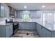 Updated kitchen featuring gray cabinets, granite countertops, stainless steel appliances at 995 Highway 101 S, Temple, GA 30179