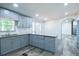 Kitchen with gray cabinets, granite countertops, and an island at 995 Highway 101 S, Temple, GA 30179