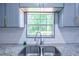 This kitchen features a stainless steel faucet and undermount sink with a view of the outdoors at 995 Highway 101 S, Temple, GA 30179