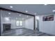Bright living room with stone fireplace, gray wood-look floors, and recessed lighting at 995 Highway 101 S, Temple, GA 30179
