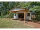A large shed features an open front and a ramp for ease of access, offering ample storage space at 995 Highway 101 S, Temple, GA 30179
