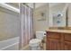 Bathroom featuring a shower/tub combo with decorative shower curtain and tiled walls at 4256 Weaver Se St, Smyrna, GA 30080
