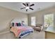 Cozy bedroom features large windows, ceiling fan, bedside table, and comfortable seating at 4256 Weaver Se St, Smyrna, GA 30080