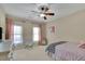 Bright bedroom with large windows, ceiling fan, and a chair for relaxing or reading at 4256 Weaver Se St, Smyrna, GA 30080