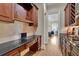 Butler pantry with dark wood cabinets and granite countertops, perfect for storage and meal prep at 4256 Weaver Se St, Smyrna, GA 30080