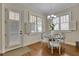 Cozy dining room with a round table, white chairs, hardwood floors, and natural light from the windows at 4256 Weaver Se St, Smyrna, GA 30080