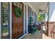 Welcoming front entrance featuring a classic wooden door, decorative wreath, and stylish porch decor at 4256 Weaver Se St, Smyrna, GA 30080