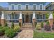 Inviting front porch with cozy seating, brick pillars, and decorative plants enhancing curb appeal at 4256 Weaver Se St, Smyrna, GA 30080