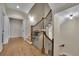 Elegant hallway featuring hardwood floors, a staircase with iron railings, and doorways to other rooms at 4256 Weaver Se St, Smyrna, GA 30080