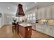 Gourmet kitchen with a center island cooktop and a custom wood vent hood at 4256 Weaver Se St, Smyrna, GA 30080