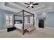 Primary bedroom with a tray ceiling and light-colored walls and flooring at 4256 Weaver Se St, Smyrna, GA 30080