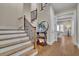 Elegant staircase with hardwood steps and an iron railing leading to the upper floors at 4256 Weaver Se St, Smyrna, GA 30080