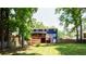Green backyard featuring the house with a deck and stairs, surrounded by mature trees at 737 Polk Nw St, Marietta, GA 30064