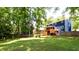 Expansive backyard showcasing the home's rear elevation, deck, and lush green space at 737 Polk Nw St, Marietta, GA 30064
