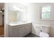 Bright bathroom with a gray dual vanity, white countertop, and a window at 737 Polk Nw St, Marietta, GA 30064