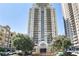 Exterior shot of a tall apartment building with flowering trees in front of it at 795 Hammond Dr # 1012, Atlanta, GA 30328