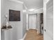 Hallway with hardwood floors, decorative art, and laundry closet at 795 Hammond Dr # 1012, Atlanta, GA 30328
