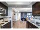 Modern kitchen open to living area with stainless appliances, stylish cabinetry and wood floors at 795 Hammond Dr # 1012, Atlanta, GA 30328