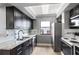 Well-lit kitchen featuring dark cabinets, stainless steel appliances, and tiled backsplash at 795 Hammond Dr # 1012, Atlanta, GA 30328