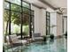 Elegant lobby area with comfortable seating, large windows, and green tiled floors, offering a welcoming ambiance at 795 Hammond Dr # 1012, Atlanta, GA 30328